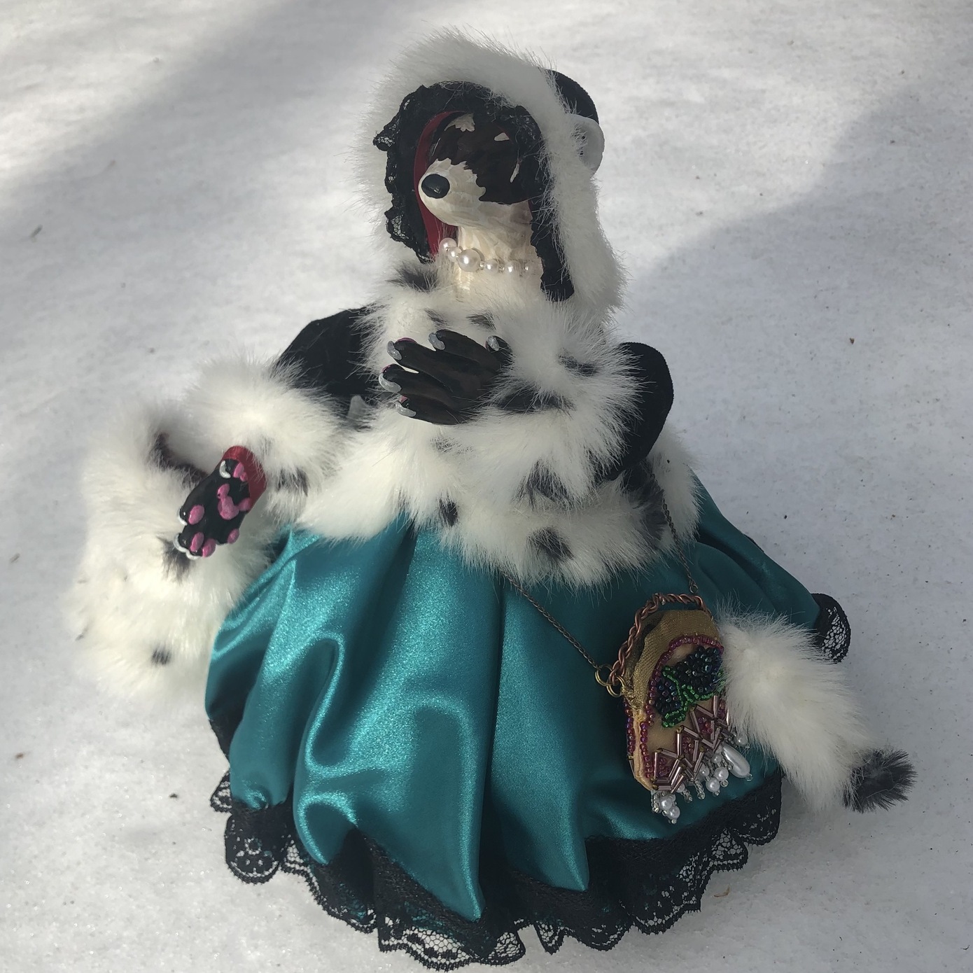 A small humanoid ferrett doll with clay face and paws, dressed in a turqoise Victorian gown. Link takes you to project page.